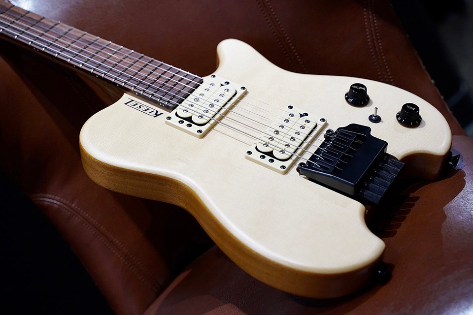 Kiesel Guitars Allan Holdsworth Signature HH2X with tremolo, white/white finish, raw tone top coat, swamp ash top, alder body, rear of body natural clear, black logo, white pickup coils, white bezels, no top inlays NIN, black plastic knobs, ebony fingerboard, black hardware