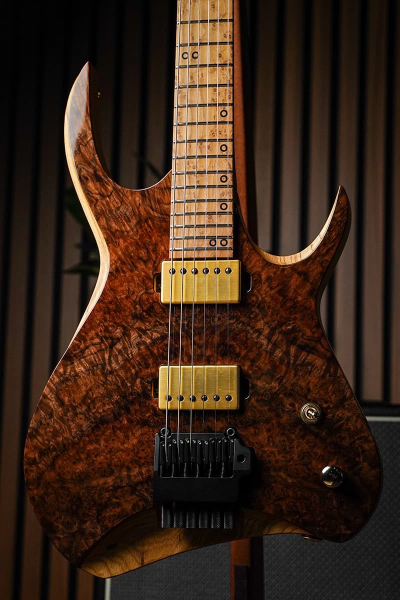 Kiesel Guitars Kyber Headless 6 string with figured claro walnut top, scooped body edges, gold pickup covers, gold hardware, and roasted birdseye maple fingerboard