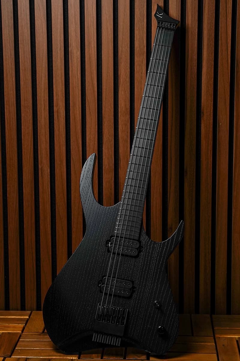 Kiesel Guitars Kyber Headless 6 string tremolo with jet black raw tone finish, richlite diamond black fingerboard, black hardware, black pole pieces, and no top inlays