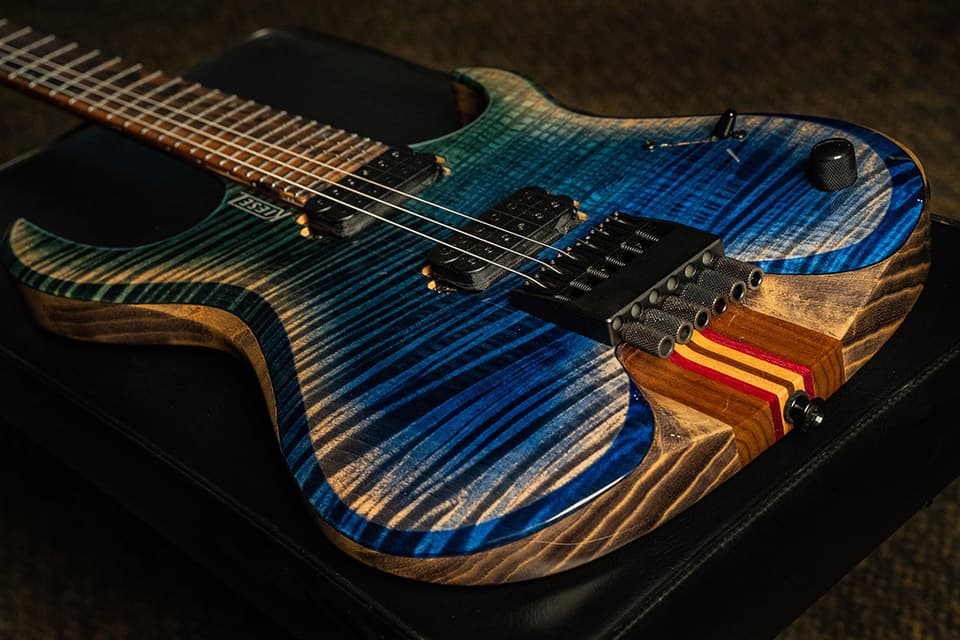 Kiesel Guitars K-Series Headless HK6 with master grade flamed maple top, master grade swamp ash body, antique ash treatment, custom aqua fade with arctic burst, rear natural clear RNC, royal ebony fingerboard, silver logo, 7-piece neck