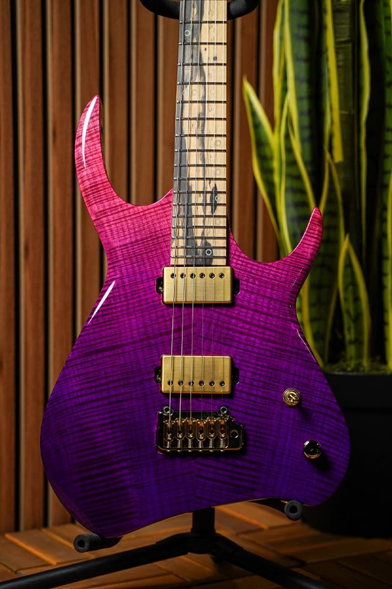 Kiesel Guitars Kyber 6 string tremolo with purple to pink fade, flamed maple top, palemoon ebony fingerboard, brushed gold pickup covers, gold pole pieces, and gold hardware