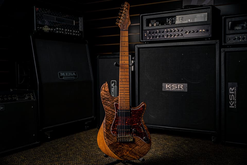 Kiesel Guitars Lyra 7 String With Master Grade Walnut Top, Red Tortoise Shell Pickguard, Gold Hardware, Black Pickup Covers, Gold Pole Pieces, Black Acrylic Dot Inlays, 3 Piece Body