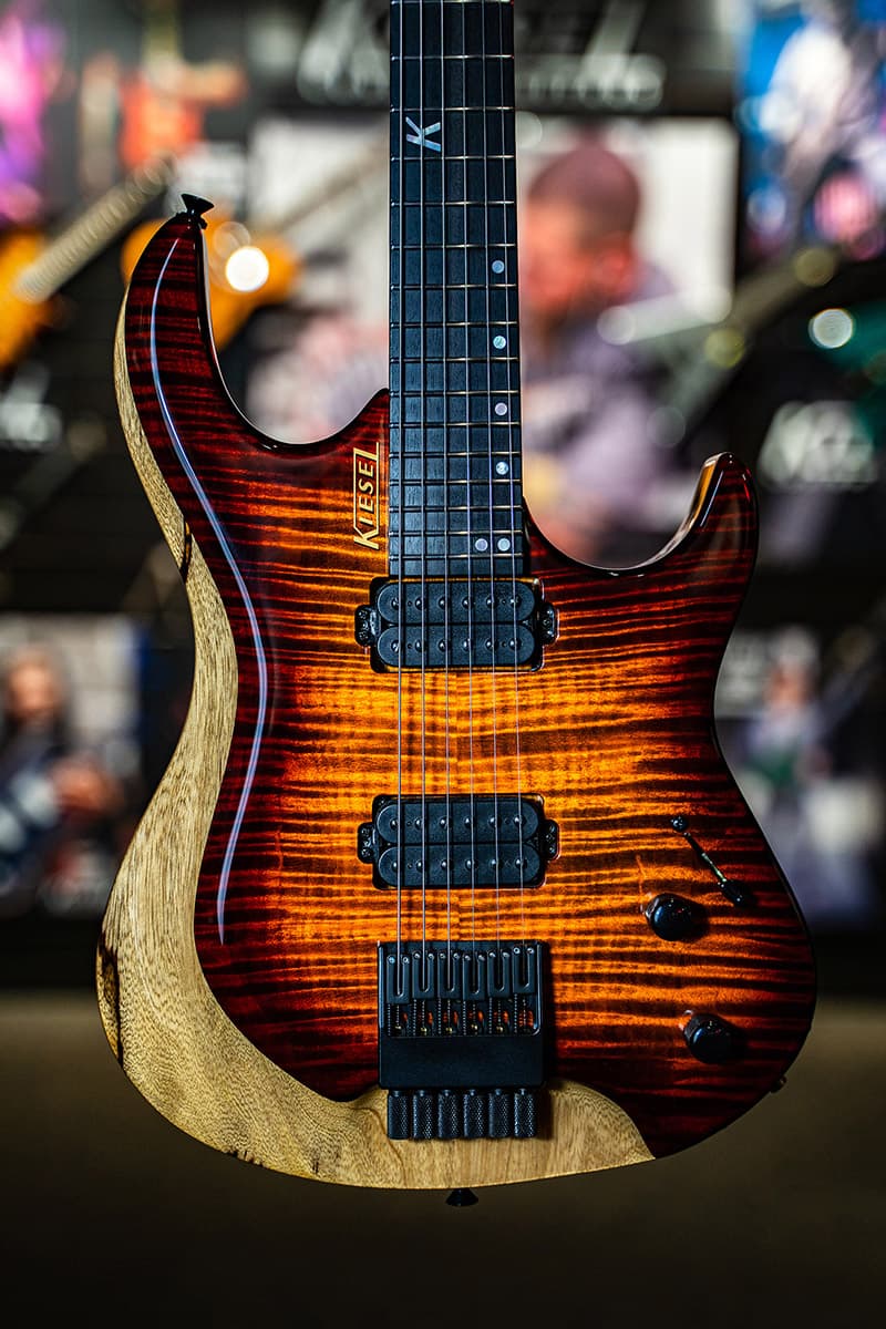 Kiesel Guitars Osiris O6 with black limba body, flamed maple top, sunburst finish, black hardware, black pickup poles, ebony less coloration fingerboard, mother of pearl 12th fret K logo staggered offset dot inlays, gold logo