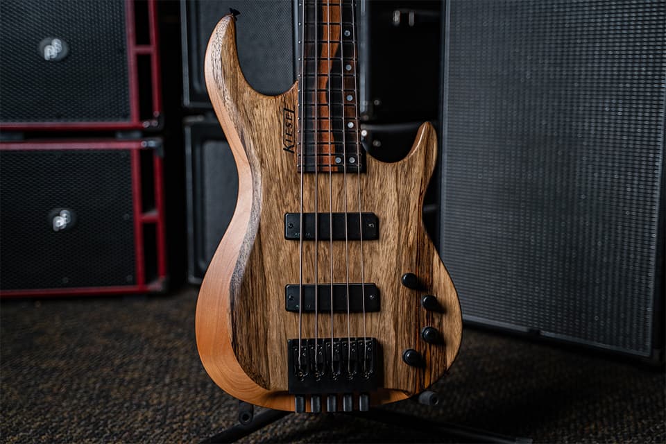 Kiesel Guitars Osiris Bass 6 String with black limba top, alder body, master grade royal ebony fingerboard, black logo, abalone staggered offset dot inlays, black hardware, kiesel radius pickups