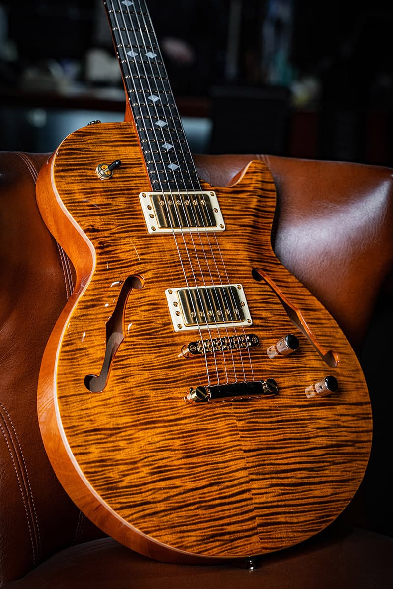 Kiesel Guitars SH550 with flamed maple top, tiger's eye finish, cream bezels, gold pickup covers, gold pole pieces, gold hardware, mother of pearl diamond inlays, ebony (less color variation) fingerboard, natural top wood binding BBE, rear natural clear RNC, mahogany body