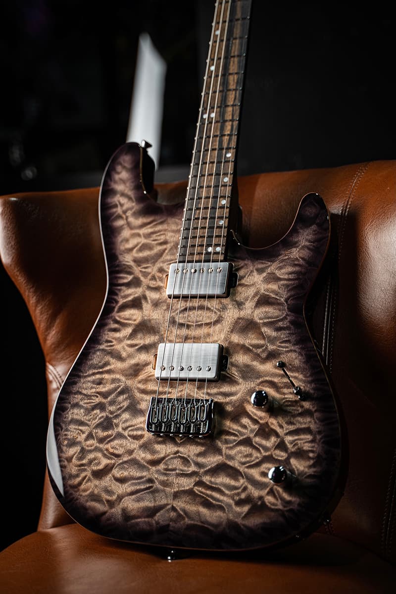 Kiesel Guitars Theos T6H with quilted maple top, black burst edges, chrome pickup covers, royal ebony fingerboard, chrome hardware white acrylic staggered offset dot inlays