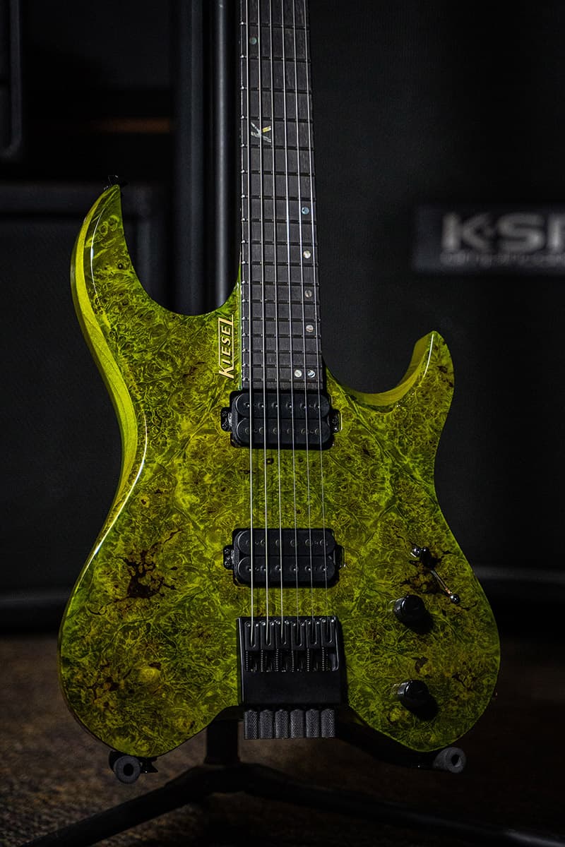 Kiesel Guitars Vader V6 with moss green finish, burled maple top, alder body, ebony less color variation fingerboard, mother of pearl 12th fret K logo with offset staggered dot inlays IKSD, black pole pieces