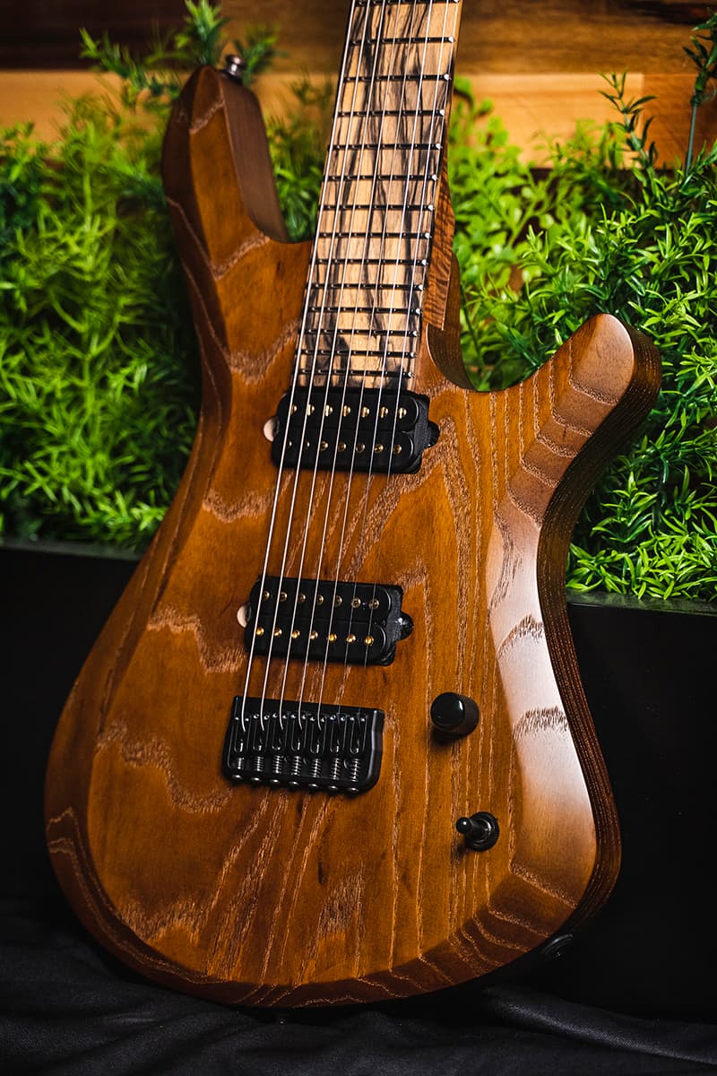 Kiesel Guitars Vanquish 7 string KV7H with 1 piece swamp ash body, select whiskey brown stain, palemoon ebony fingerboard, gold pole pieces, black hardware