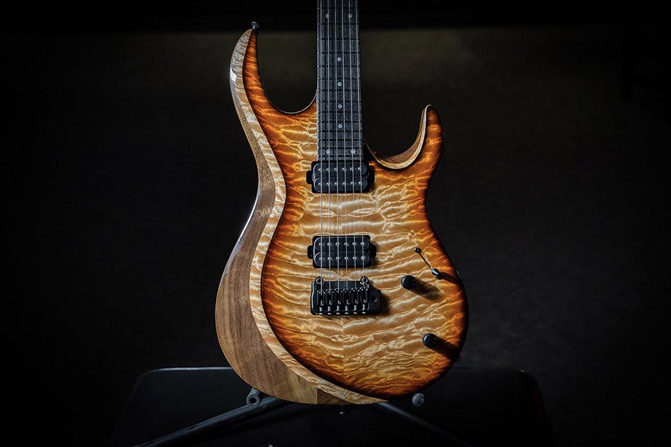Kiesel Guitars Aries Neck-Through (NA6X) With honey california burst finish, black burst edges, kiesel/hipshot tremolo, black hardware, rear natural back and sides (RNC), walnut body, quilted maple top, natural top wood body binding on bevel (BBEB), ebony (less color variation) EFB fingerboard, mother of pearl dot inlays