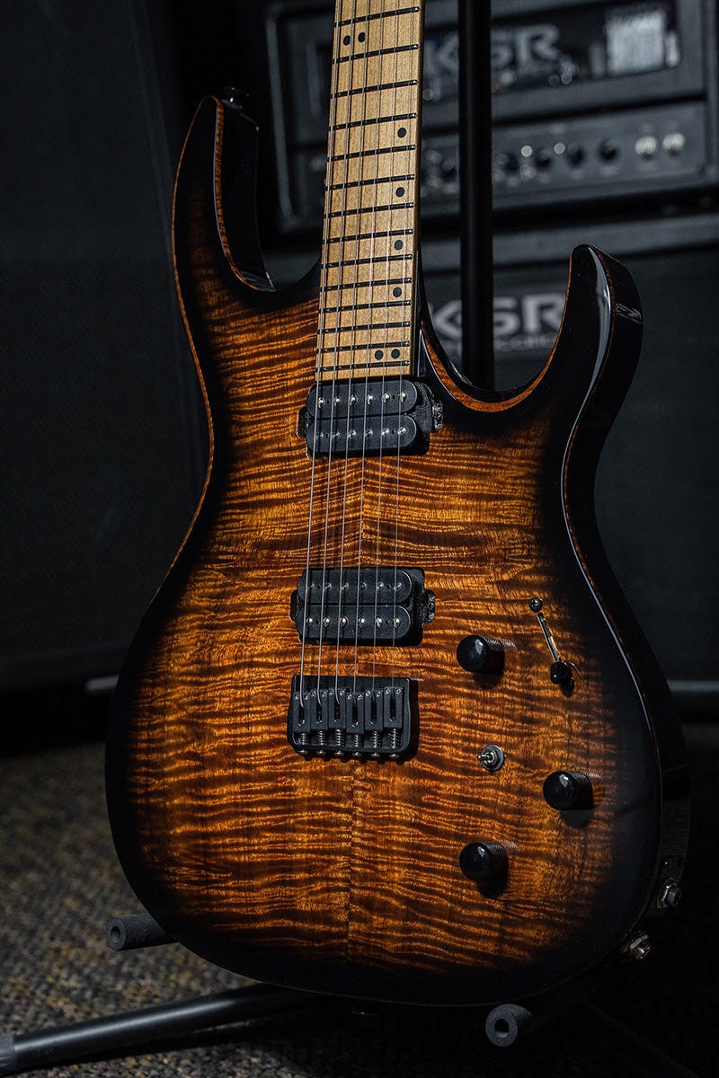 Kiesel Guitars DC DC600H with flamed koa top and translucent black burst edges, roasted maple fingerboard, black acrylic staggered offset dot inlays, black hardware