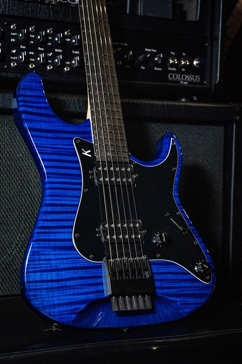 Kiesel Guitars delos headless HD6 with flamed maple top, translucent blue finish, ebony fingerboard, black pickguard, black plastic knobs