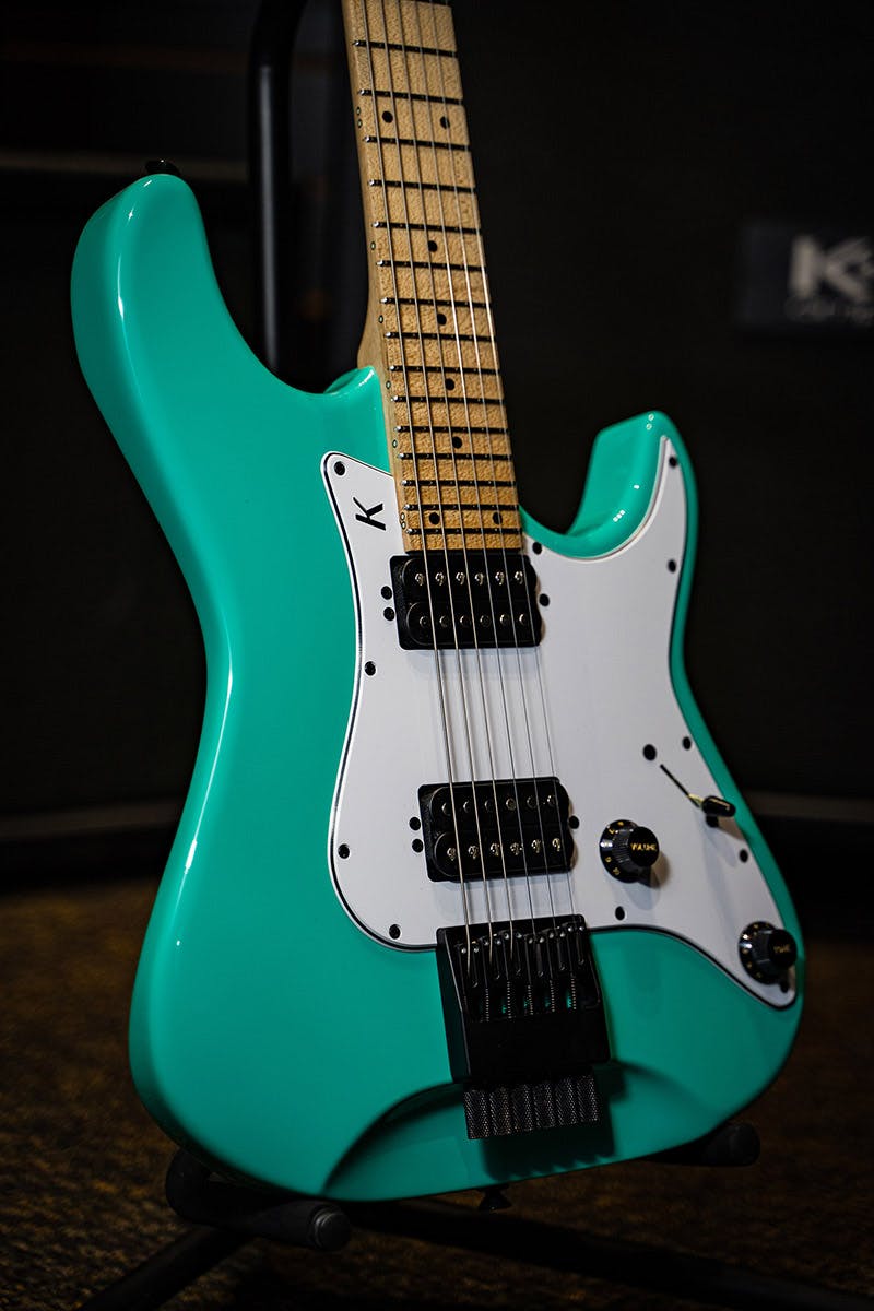 Kiesel Guitars delos headless HD6 with seafoam green finish, white pickguard, chrome pickup poles, maple fingerboard, black acrylic dot inlays