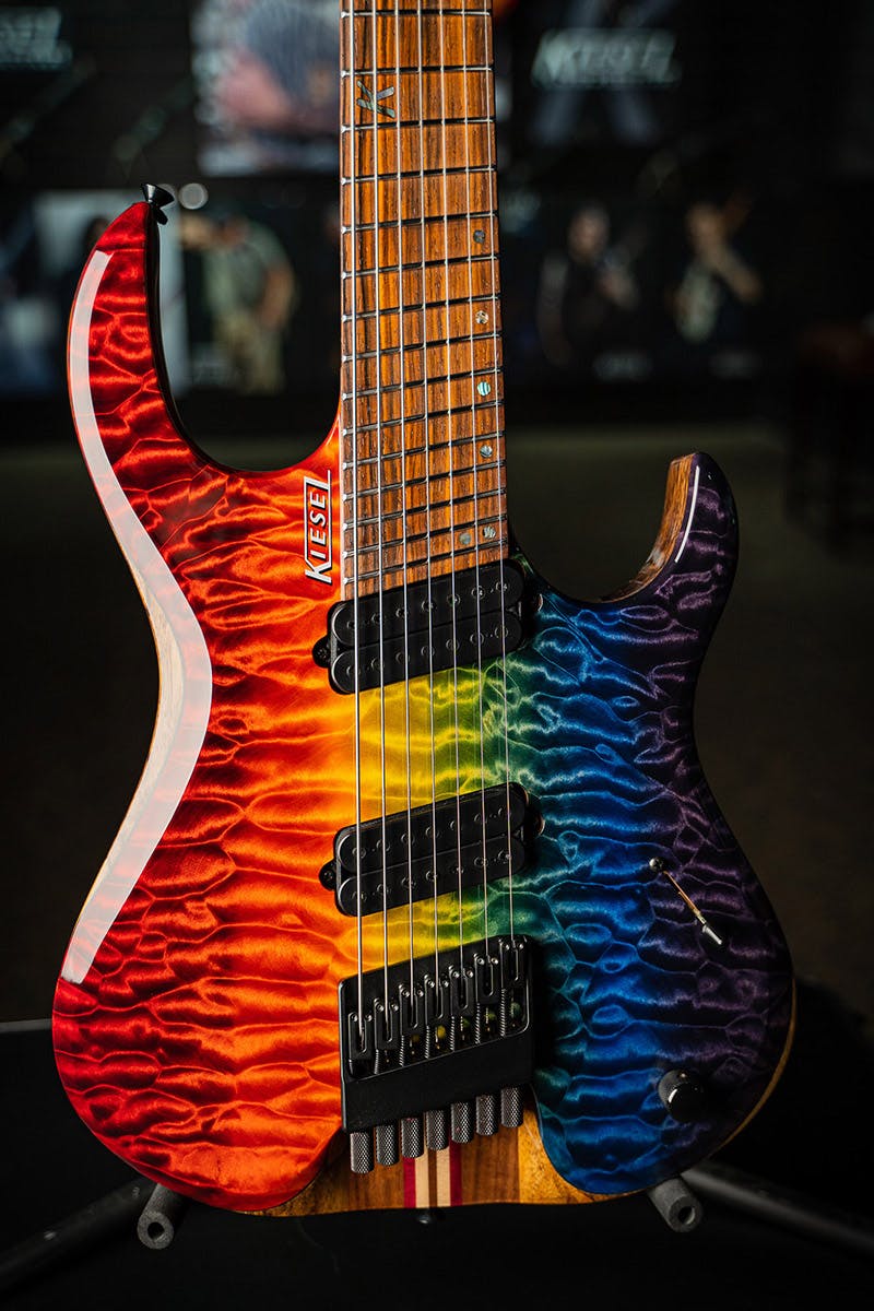 Kiesel Guitars K-Series Headless multiscale 7 string HKM7 with mater grade quilted maple top, custom rainbow finish, roasted maple fingerboard, black hardware, black pole pieces, 7 piece walnut neck black limba body