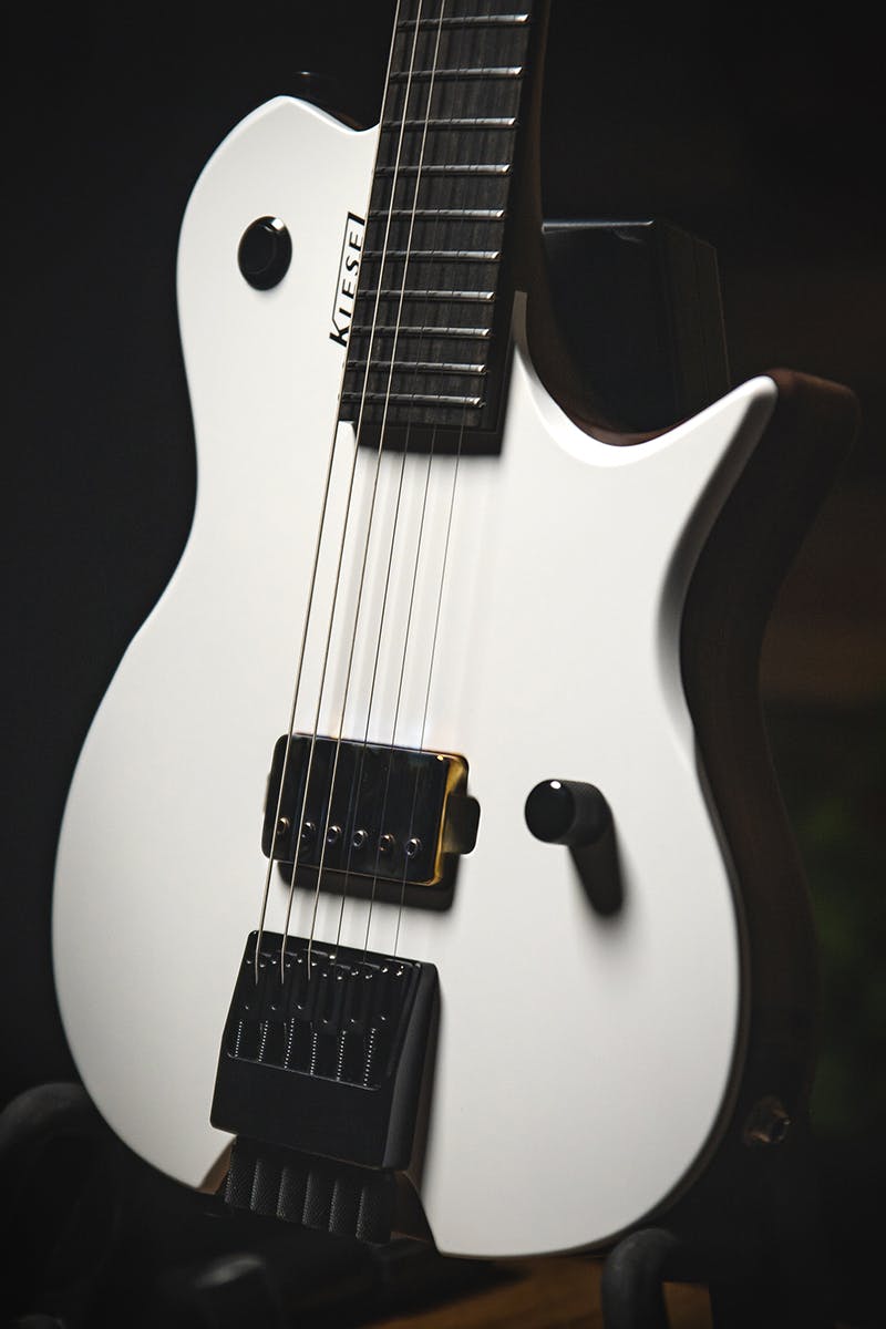 Kiesel Guitars Leia L6 with white/white finish, neck pickup delete, chrome pickup cover, black hardware, black logo, custom kill switch, ebony fingerboard, walnut body
