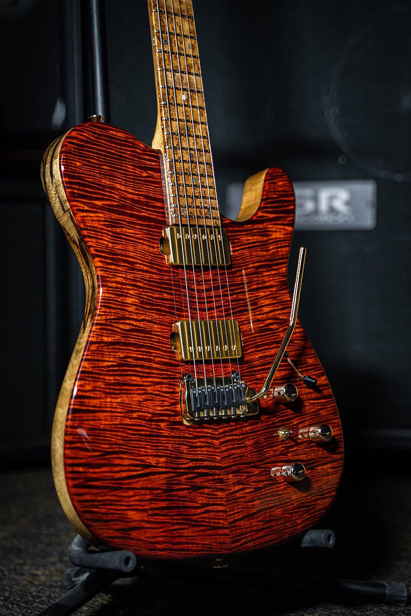 Kiesel Guitars Solo tremolo S6X with black limba body, rear natural clear RNC, flamed maple top, lava stain finish, gold hardware, gold pickup covers, gold pole pieces, acoustic saddles AS, roasted birdseye maple fingerboard, mother of pearl dot inlays