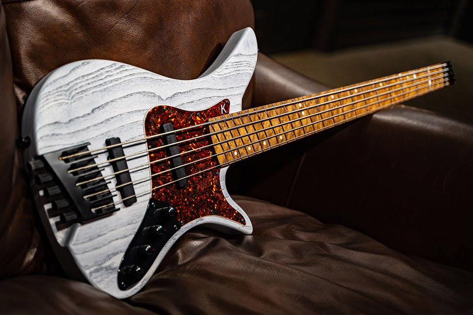 Kiesel Guitars Thanos Multiscale Bass With White/White Finish, Raw Tone top coat, red tortoise shell pickguard, black hardware, roasted birdseye maple fingerboard, white acrylic staggered offset dot inlays, swamp ash body