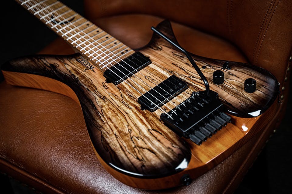 Kiesel Guitars Thanos Guitar TG7X tremolo with spalted maple top, translucent black burst edges, black pickup covers, roasted maple fingerboard, crescent moon black acrylic staggered offset dot inlays ICSD, mahogany body