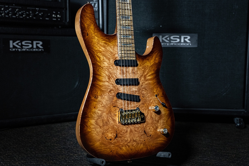 Kiesel Guitars Theos tremolo T6X with burled maple top, honey burst finish, gold hardware, roasted flamed maple fingerboard, mother of pearl block inlays, abalone knob inlays, alder body