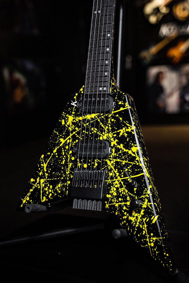 Kiesel Guitars Type-V TV6 with jet black finish, mclaren yellow splatter, white pearl staggered offset dot inlays, white K logo, black hardware