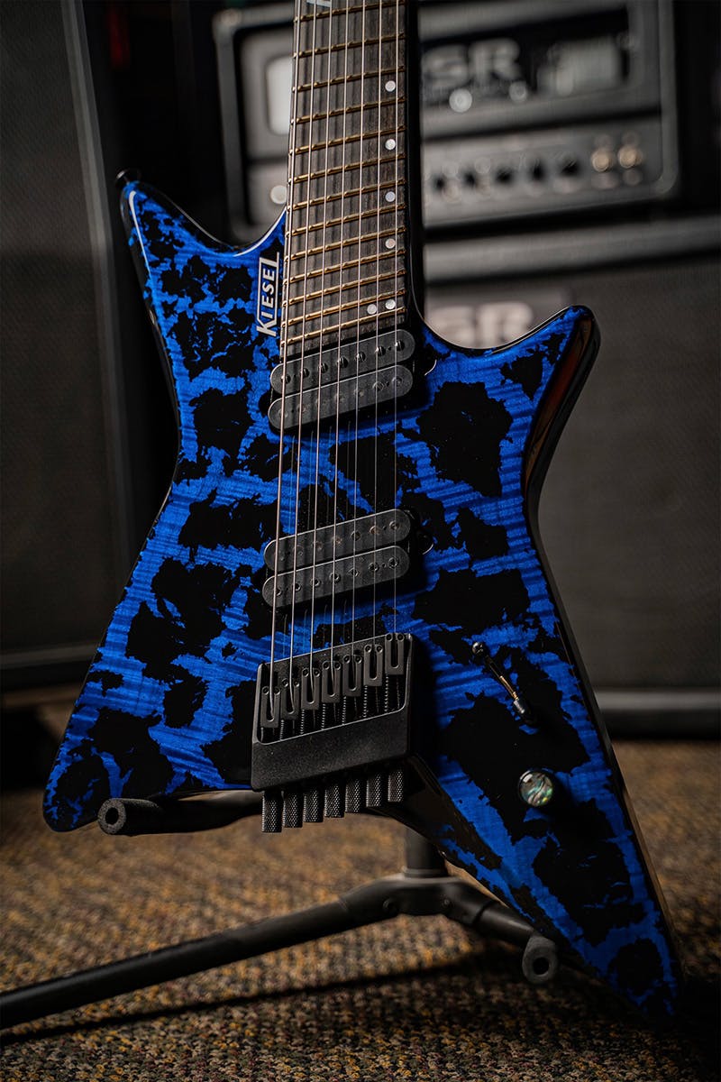 Kiesel Guitars Type-X XM6 multiscale with flamed maple top, translucent blue finish, black crackle, dropshadow silver logo, black hardware, ebony (less color variation) fingerboard, abalone inlay knob, white pearl staggered offset dot inlays