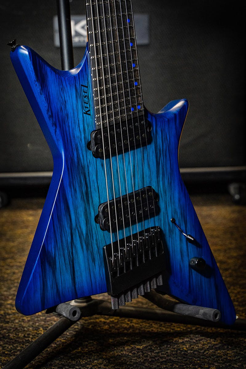 Kiesel Guitars Type-X multiscale 8 string XM8 with translucent blue finish, black limba top, black logo, ebony (less color variation) fingerboard, blue acrylic staggered offset dot inlays, black hardware