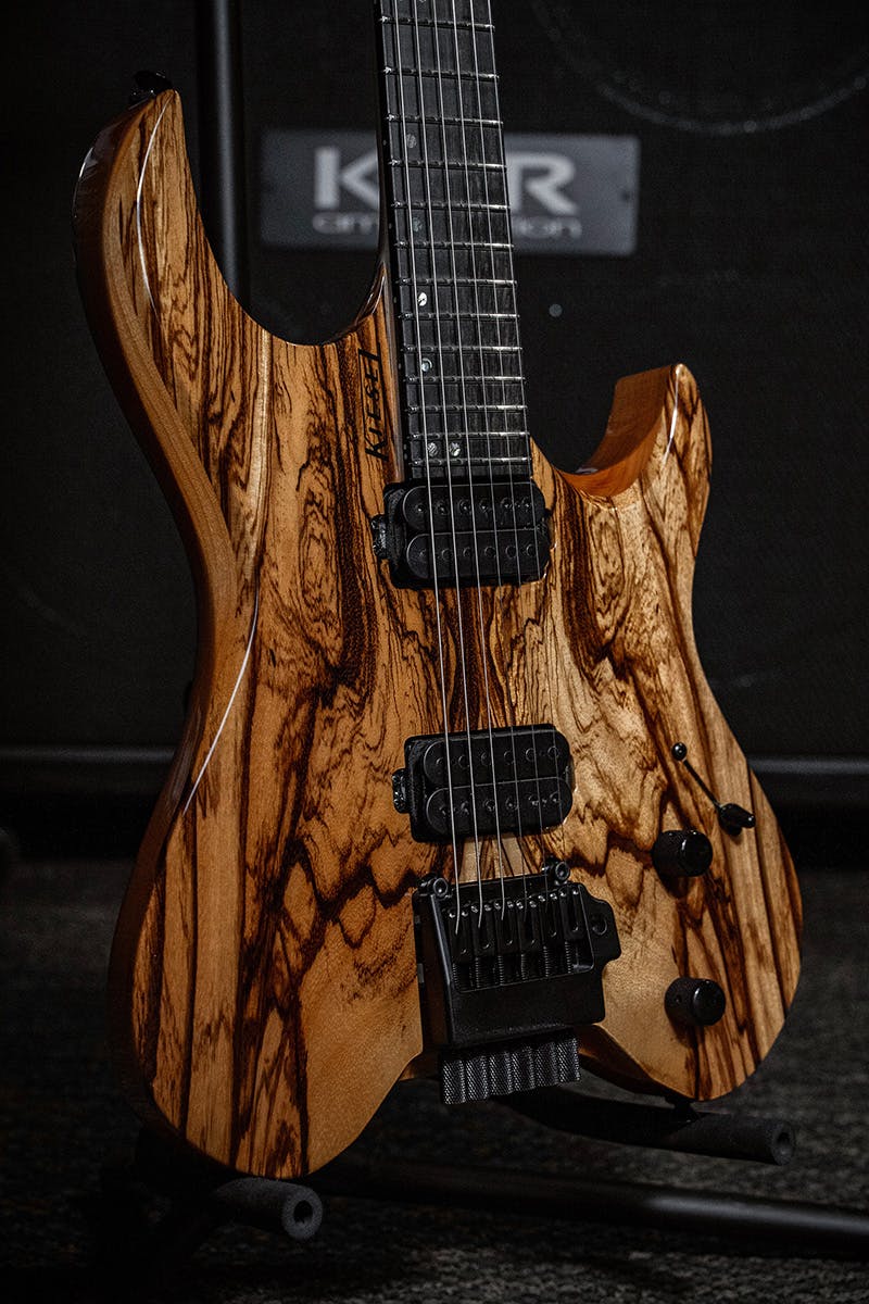Kiesel Guitars Vader V6X tremolo with zebrawood top, mahogany body, black logo, ebony less color variation fingerboard, black hardware, offset mother of pearl dot inlays