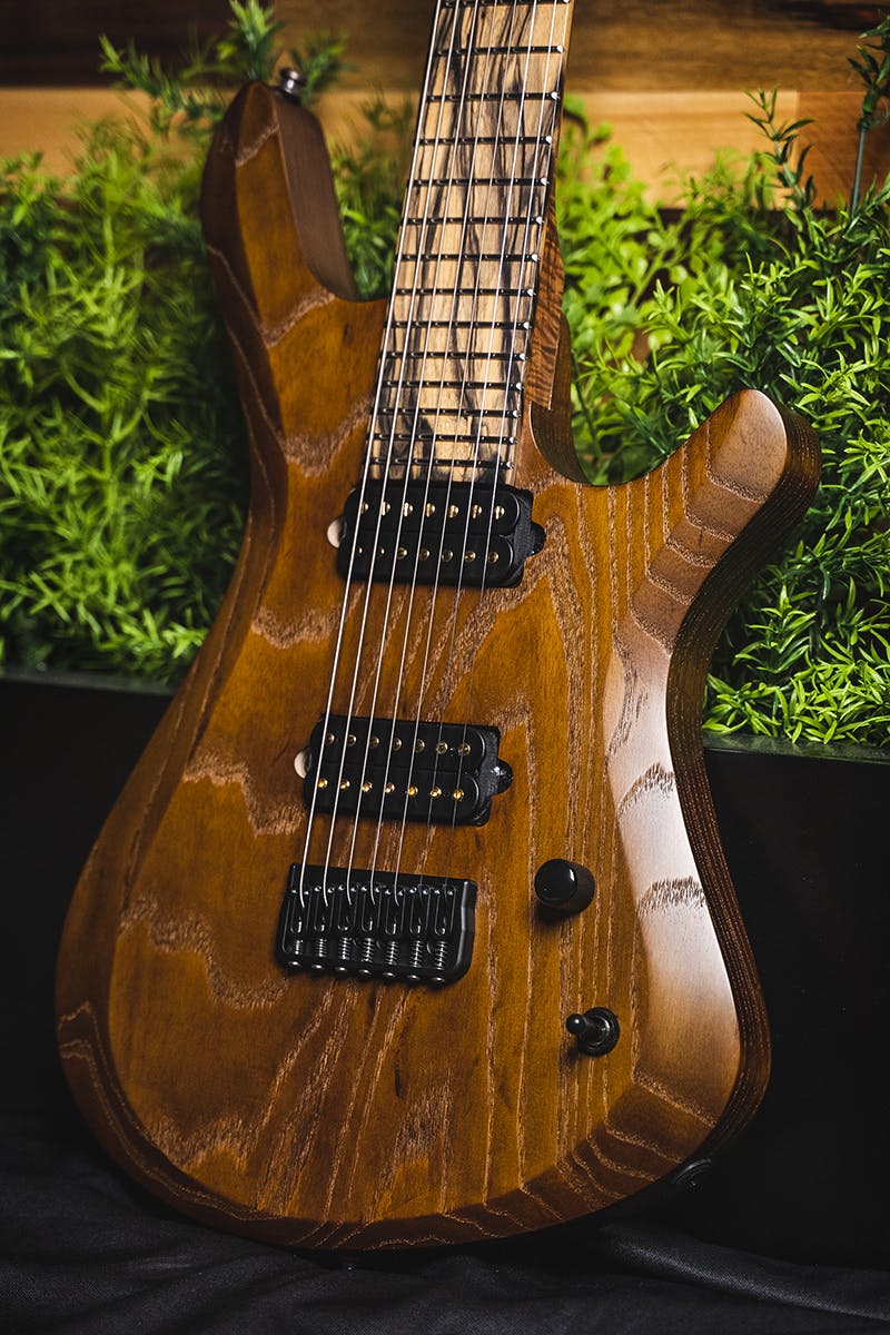 Kiesel Guitars Vanquish 7 string KV7H with 1 piece swamp ash body, select whiskey brown stain, palemoon ebony fingerboard, gold pole pieces, black hardware