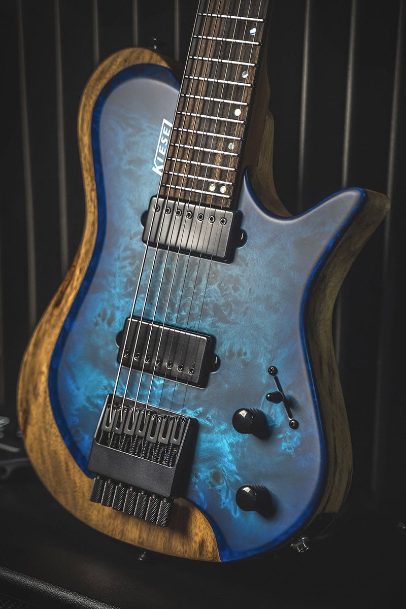 Kiesel Guitars Zeus 7 string Z7 with aqua burst finish, poplar top, rear natural clear RNC, black limba body, black pickup covers, black pole pieces, royal ebony fingerboard, mother of pearl staggered offset dot inlays, white logo