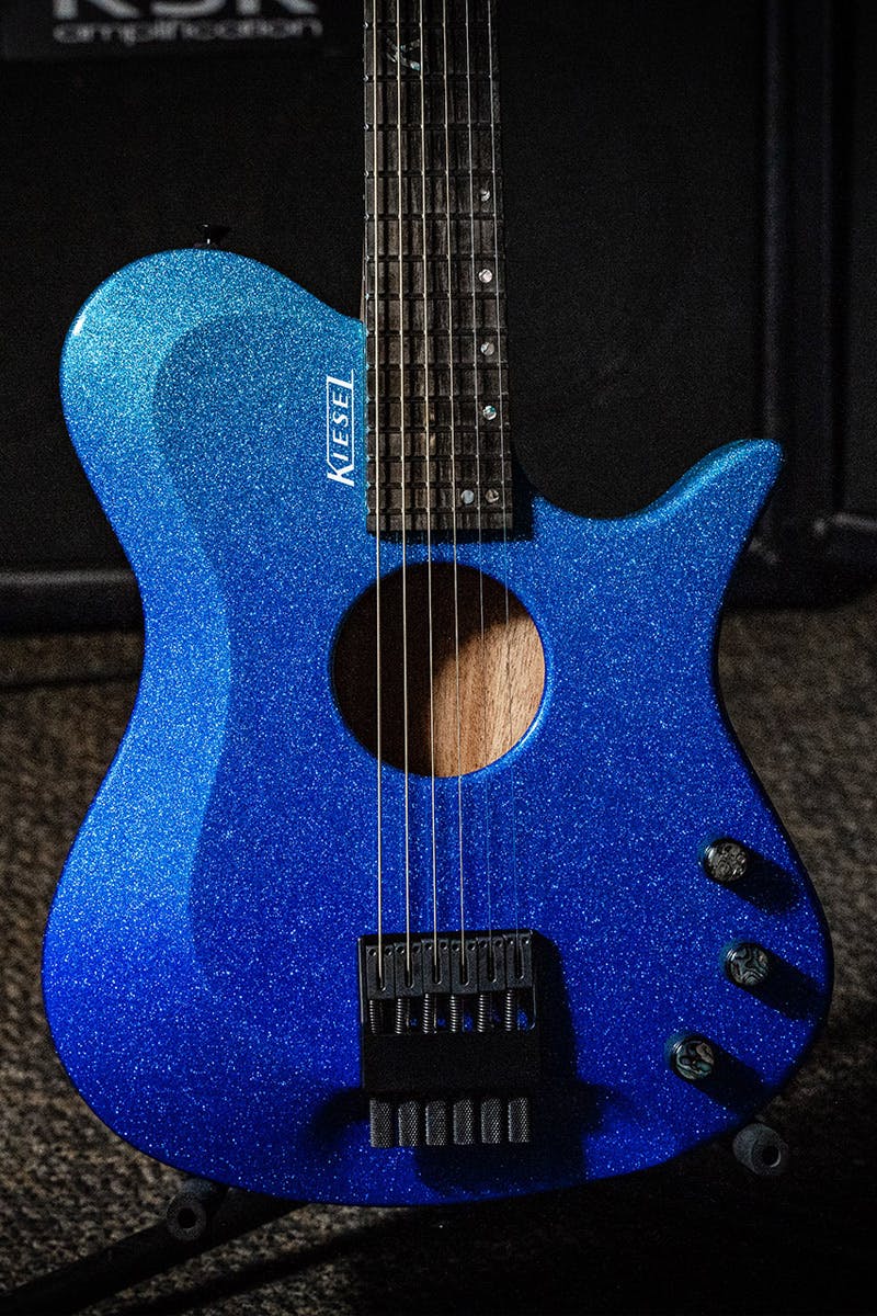 Kiesel Guitars Zeus Acoustic ZA6 with mahogany body, sparkle translucent blue finish, abalone knob inlays, white logo, ebony fingerboard