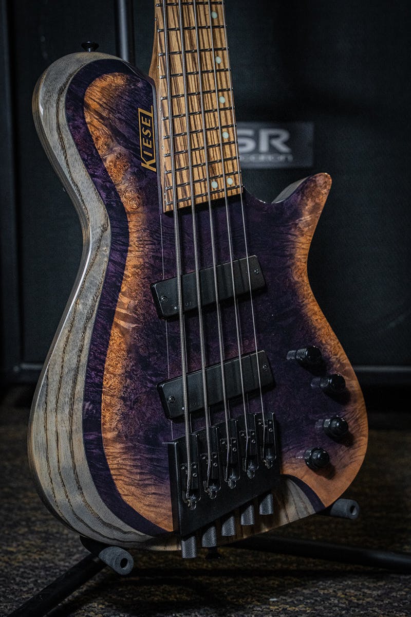 Kiesel Guitars Zeus Bass 5 String Multiscale With custom shop finish, burl maple top, custom arctic style binding effect, rear of body natural clear RNC, swamp ash body, antique ash treatment, zebrawood fingerboard, mother of pearl staggered offset dot inlays, dropshadow gold logo, kiesel radius pickups, black hardware