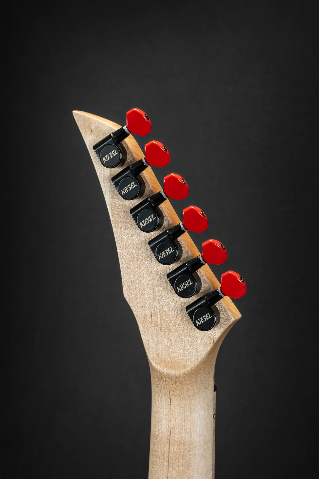 Kiesel headstock with colorful logo and premium red tuning pegs